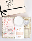 BOXFOX creme gift box packed with "Table for Two"cookbook, salt bag, white spoon rest, marble salt cellar and olive oil