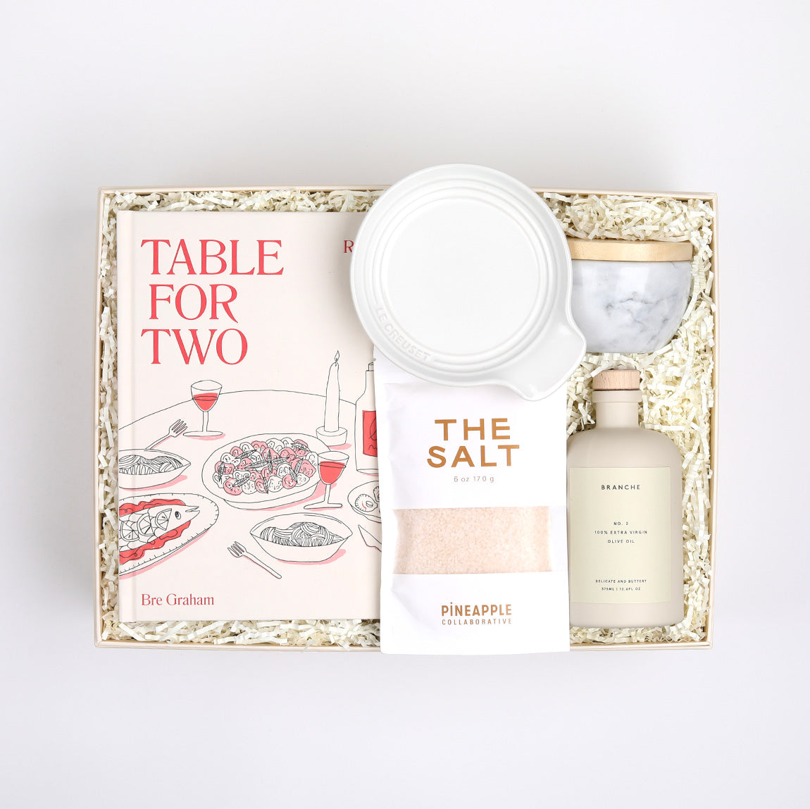 Table for Two ready to ship in creme featuring &quot;Table for Two&quot; cookbook, Le Creuset spoon rest, Branche olive oil, The Salt, and marble salt cellar