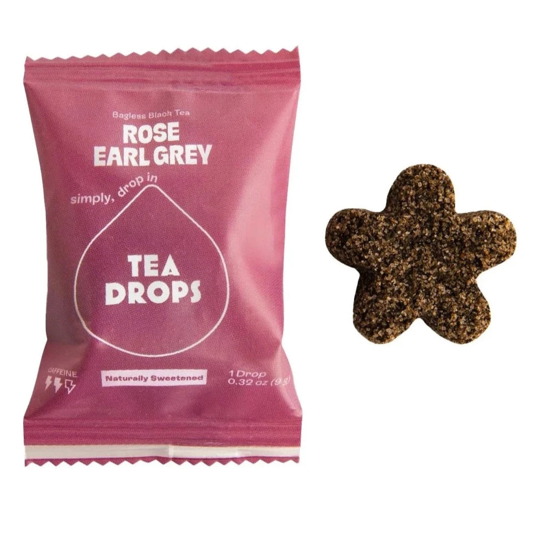purple bag with white text for tea drop. star shaped tea drop next to it