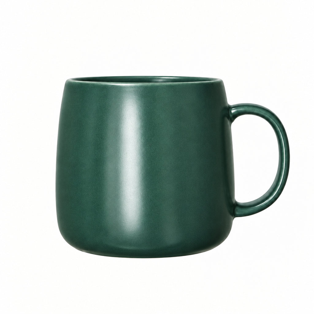 Green mug on a wooden surface with a plain background