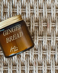 mini amber candle jar with 'GINGERBREAD' printed on it