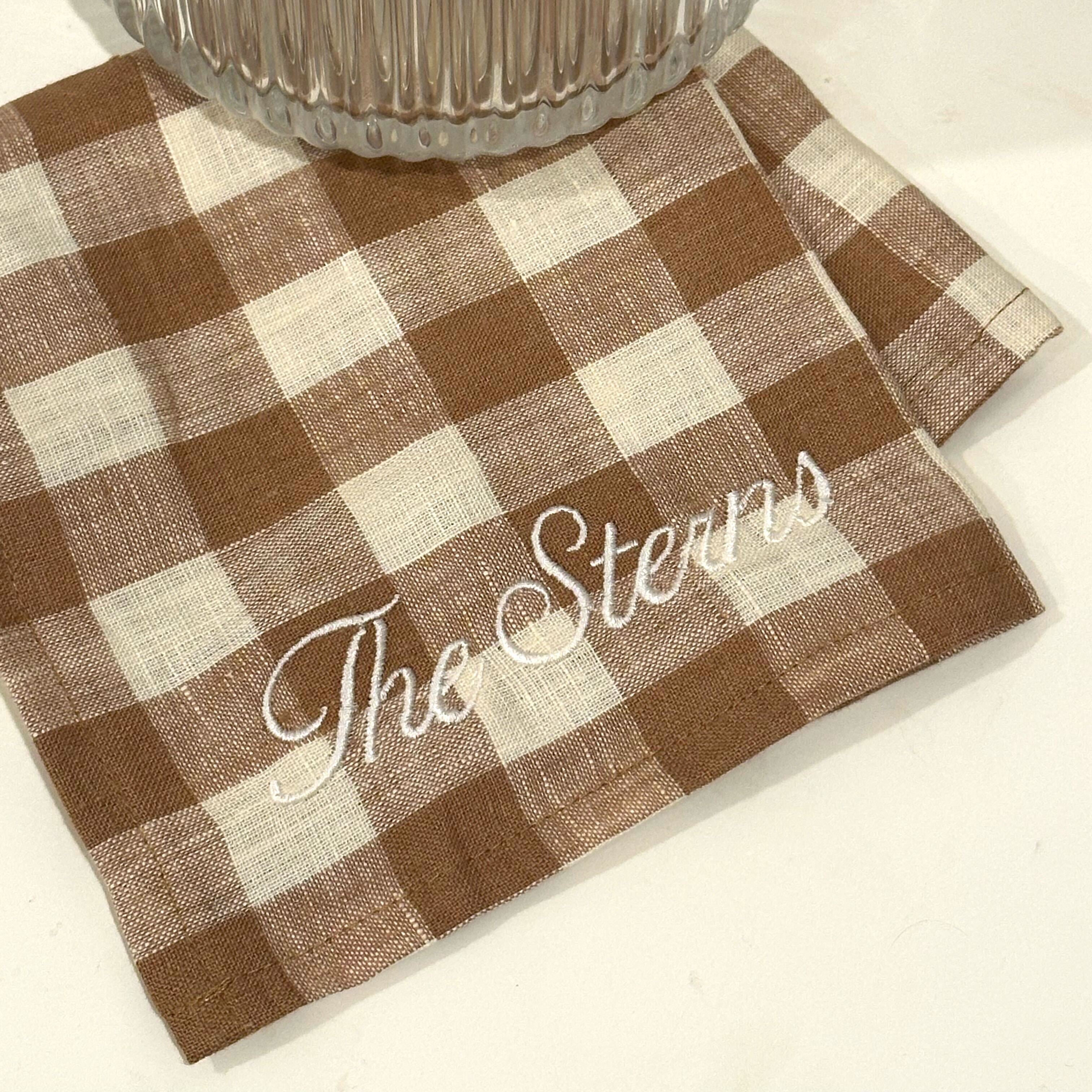 Checkered placemat with 'The Steins' text on a white surface
