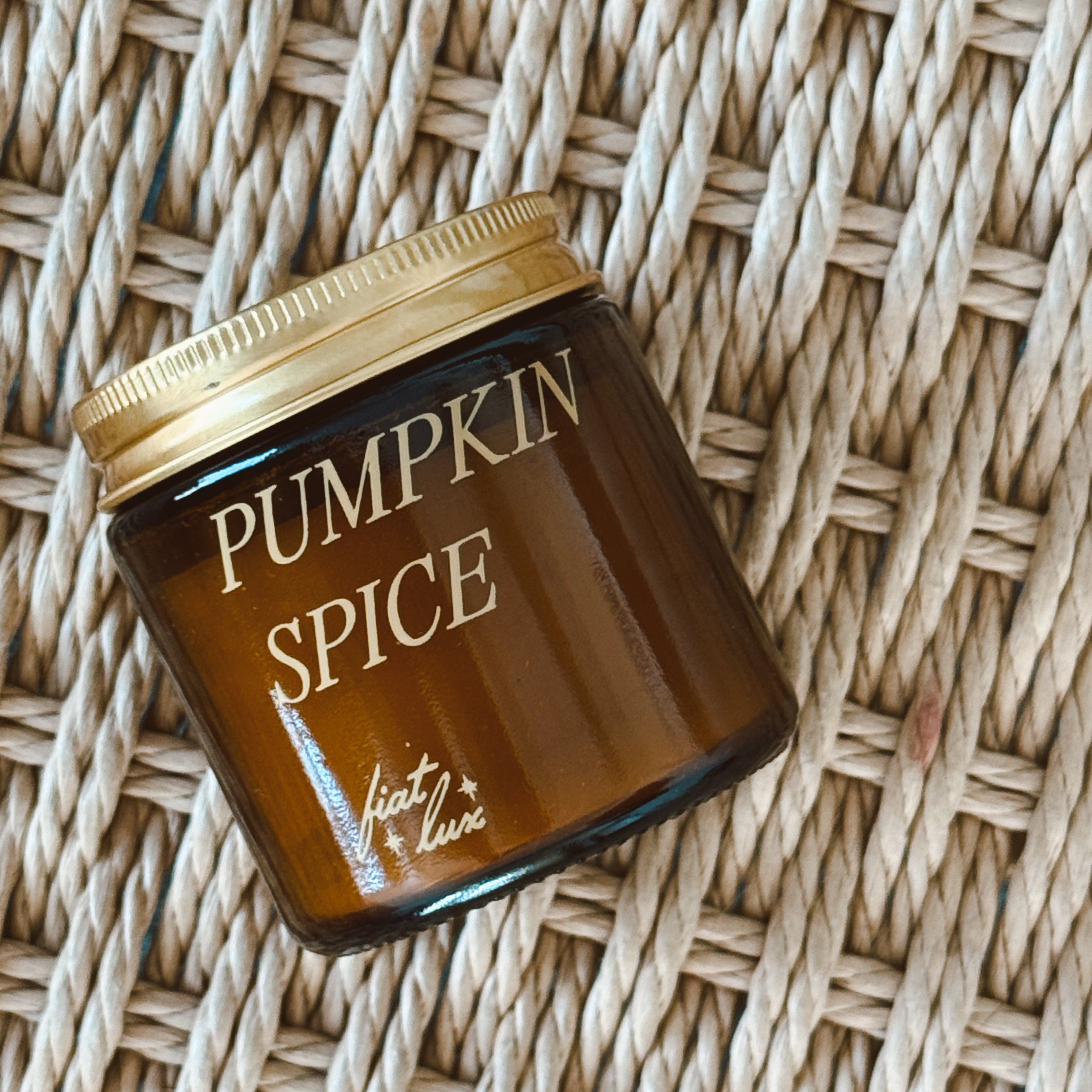 mini amber candle jar with &#39;PUMPKIN SPICE&#39; printed on it