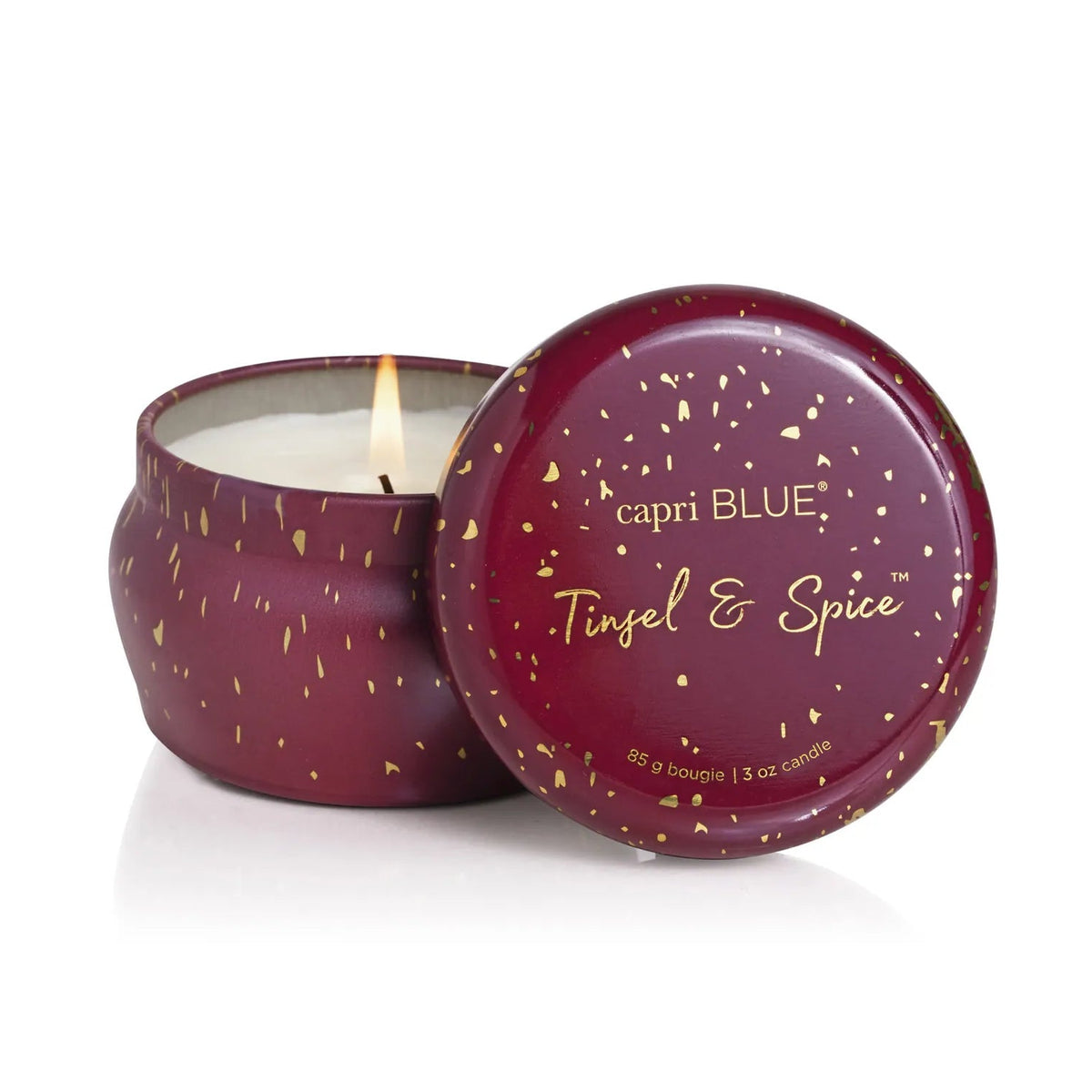 Capri Blue candle with 'Tinsel & Spice' scent on a white background