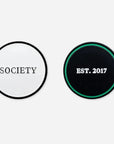 2 ball markers: 1 white with 'society' written on it in black, 1 black and green with 'est. 2017' written on it in white