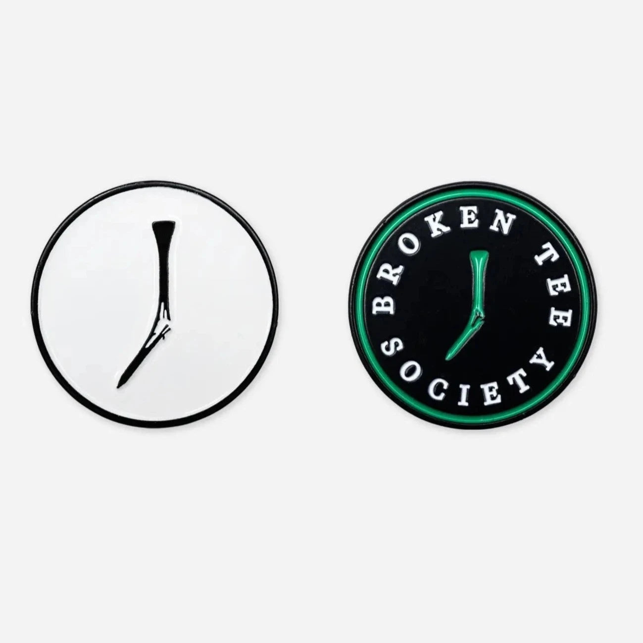 2 ball Markers: 1 black & white with a broken tee, 1 black with a green broken tee and 'broken tee society' written on it in white letters