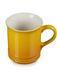 A Le Creuset Le High Life mug in a vibrant yellow color with a glossy finish and a contrasting white interior, shown on a plain white background.