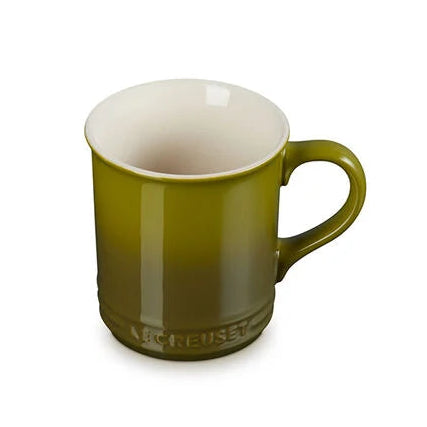 Green mug with a white interior on a white background
