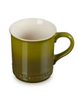 Green mug with a white interior on a white background