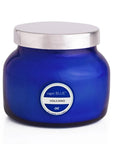 Blue candle jar with silver lid on a white background