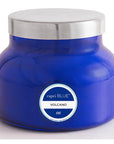 Blue candle jar with silver lid and 'capri BLUE' label on a white background