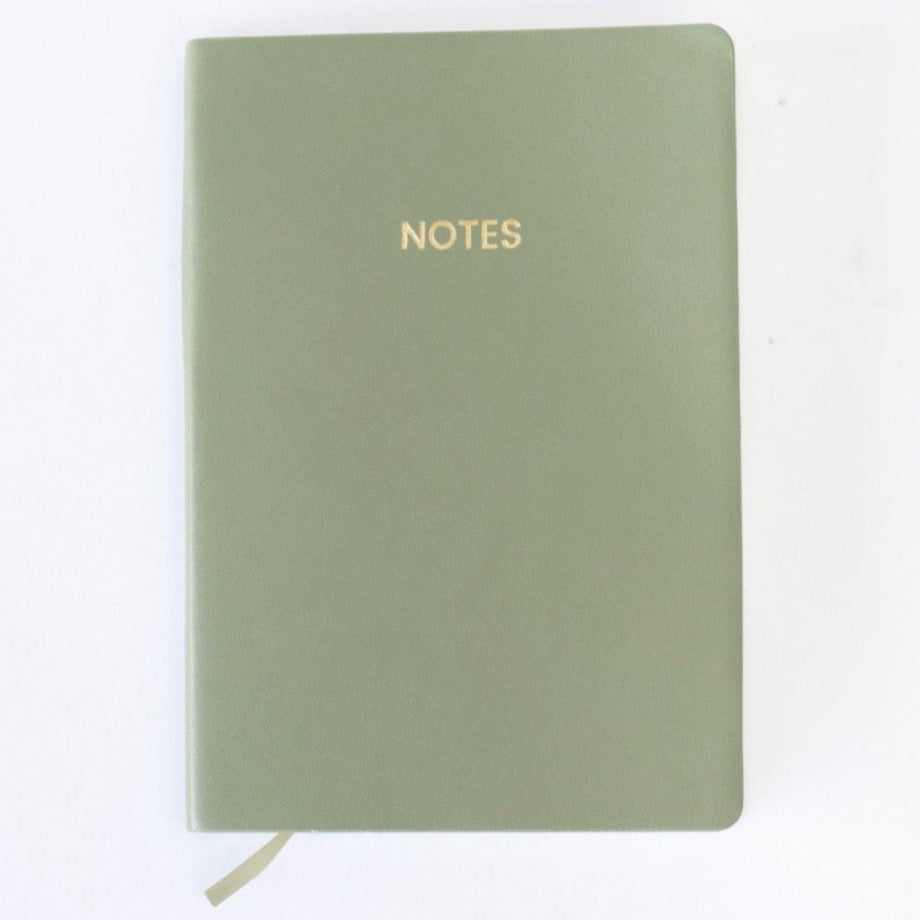 An olive green colored vegan leather notebook with gold foil text reading &quot;NOTES&quot; across the front photographed against a white background.