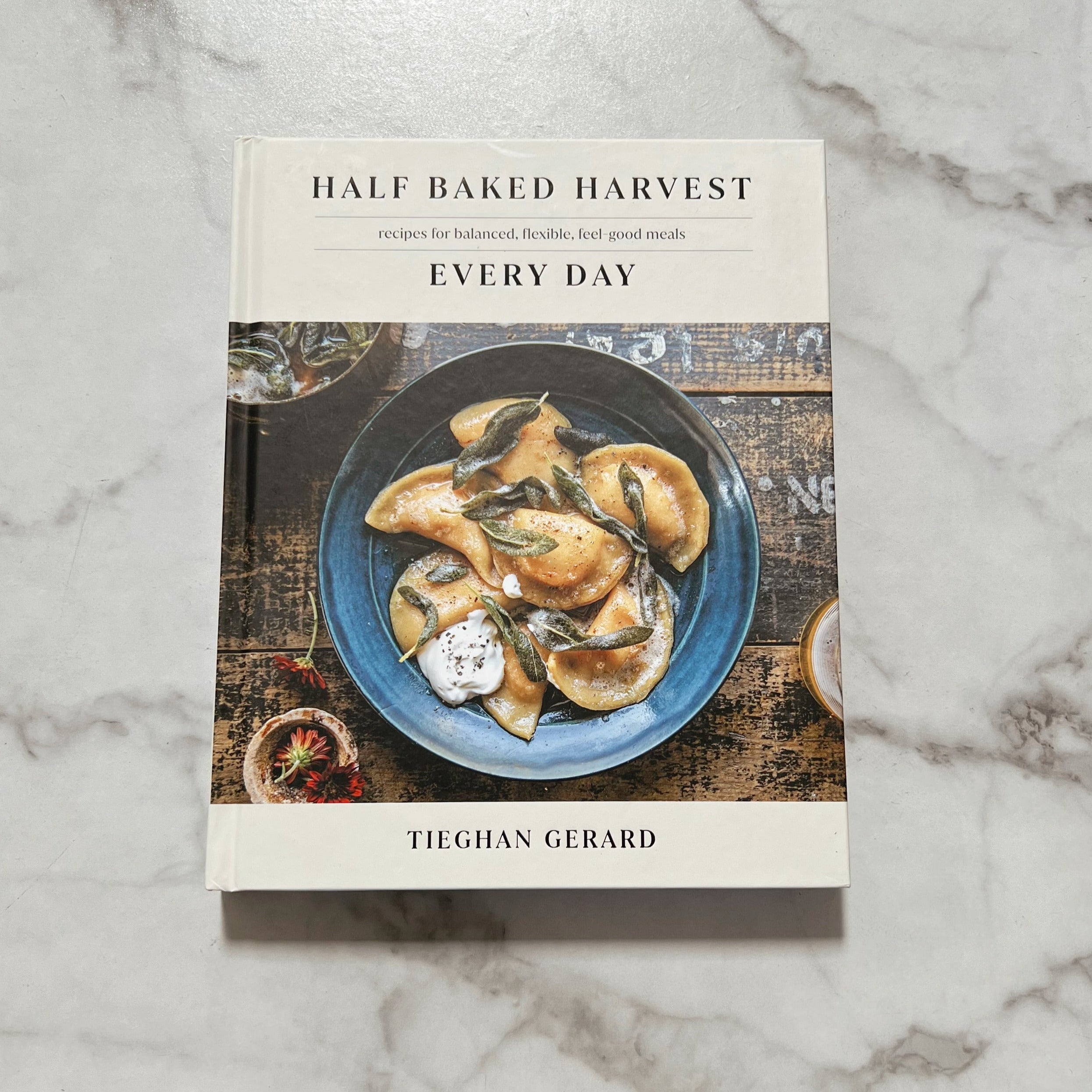 Half Baked Harvest cookbook featuring pierogis in a blue bowl on the cover.