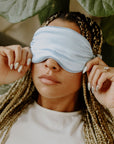 Girl with brunette and blonde braids wearing a blue silk sleep mask