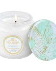 Laguna scented candle with teal lid and accents on the label. lid is off leaning against the lit candle