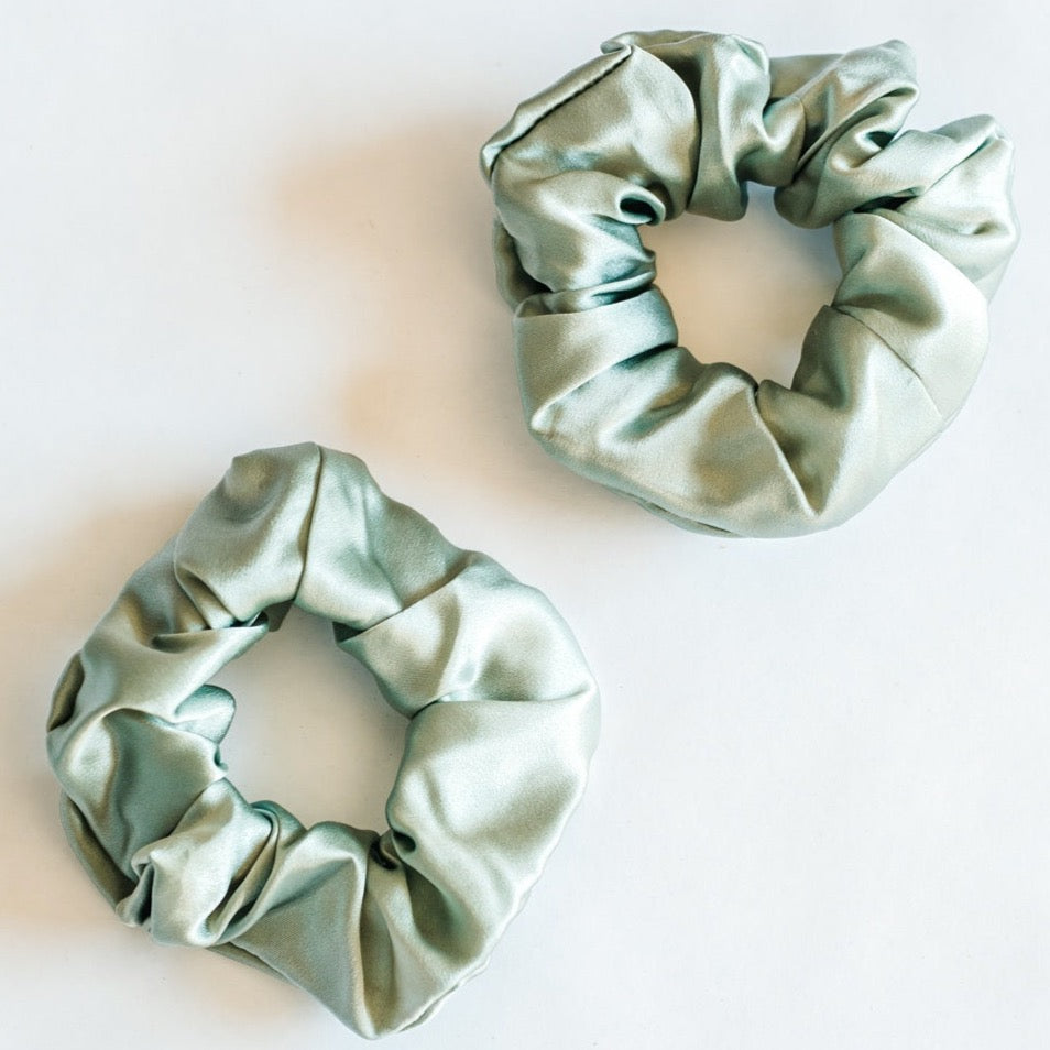Two thick sage green srunchies.
