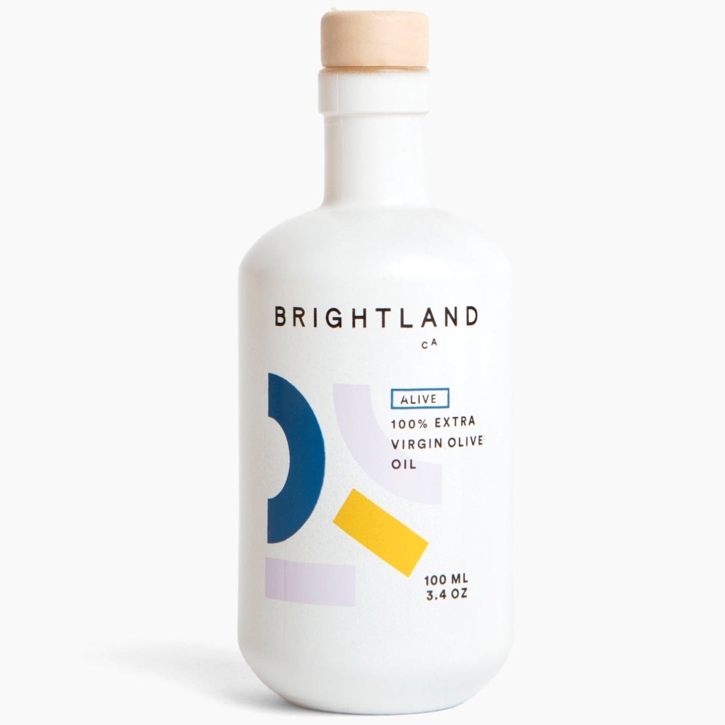 A white bottle with blue, yellow and grey geometric motifs and the following in black writing, "BRIGHTLAND CA ALIVE 100% EXTRA VIRGIN OLIVE OIL 100ML 3.4 OZ" photographed on white background.