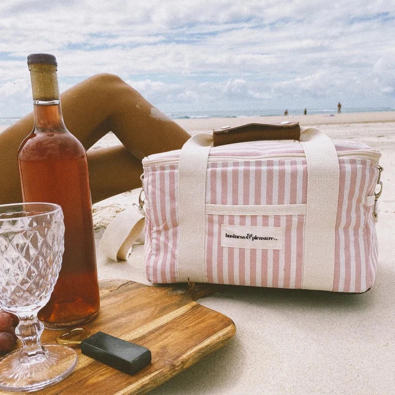 pink striped premium cooler bag on the sand at the beach