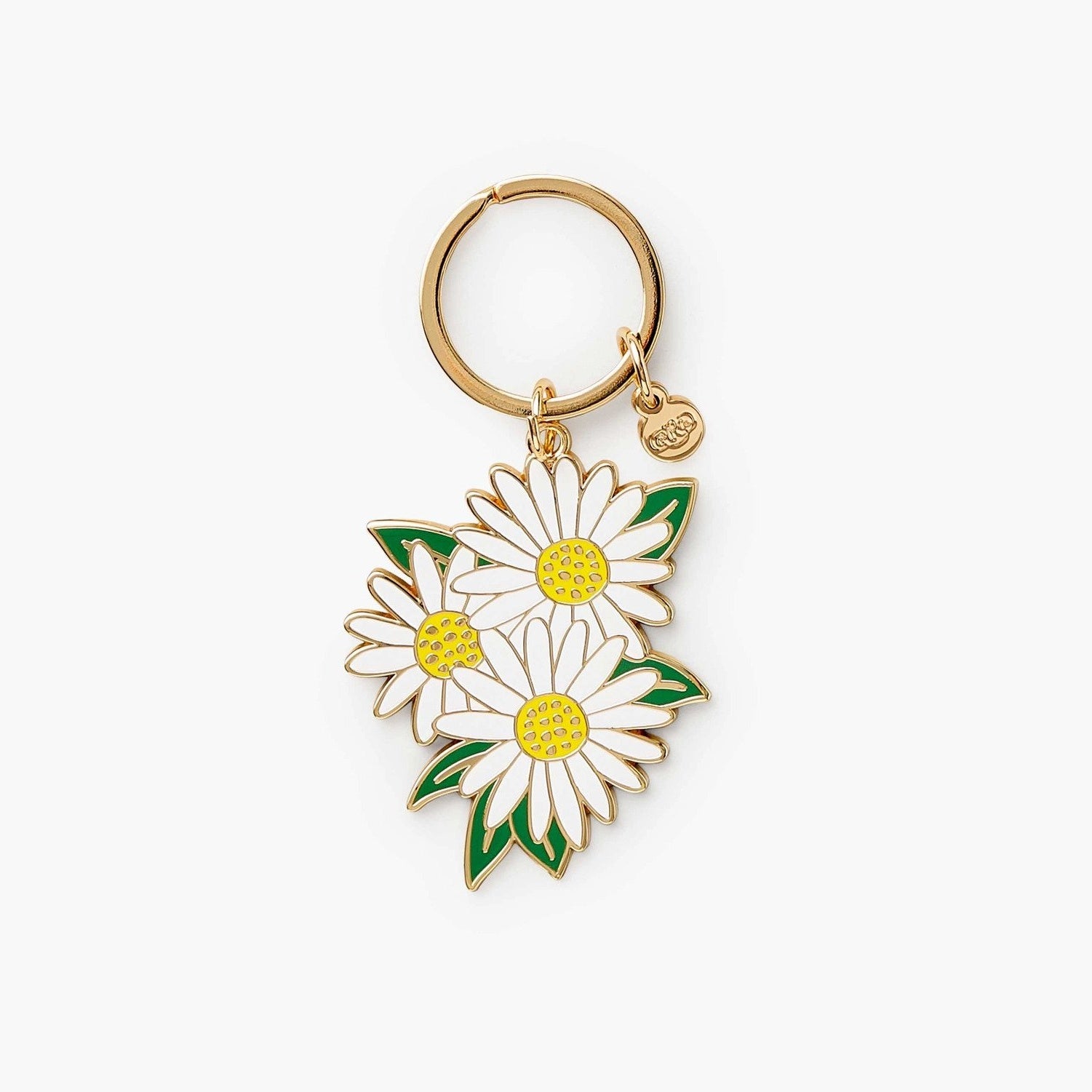 Three white daisies with yellow centers on a gold key ring.