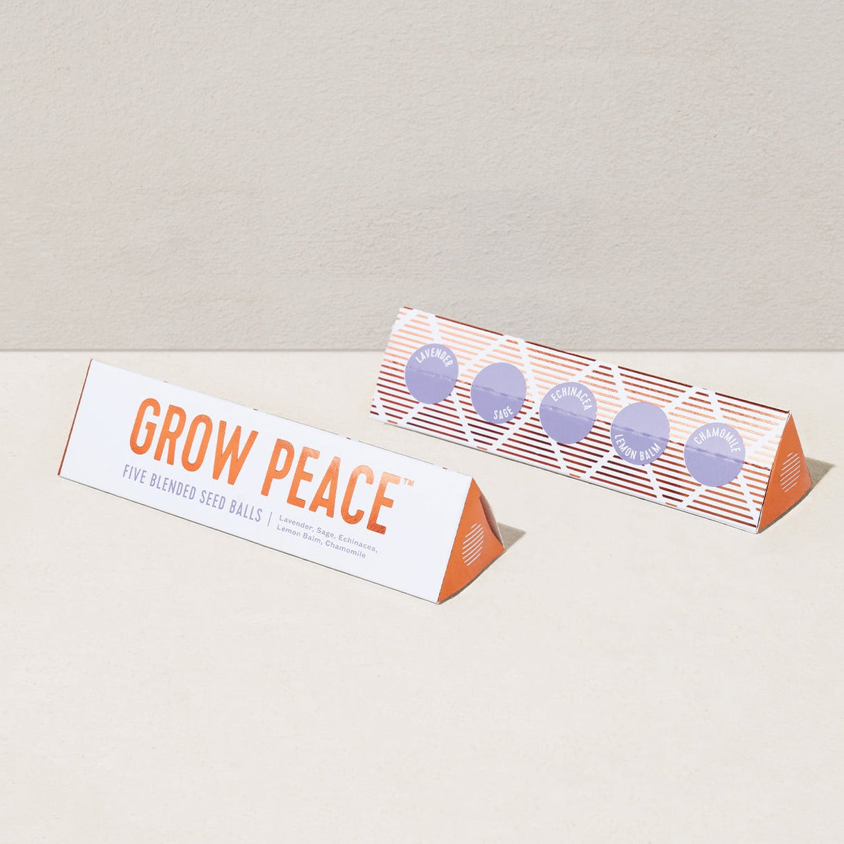 Long box of seed balls with orange text that reds GROW PEACE.