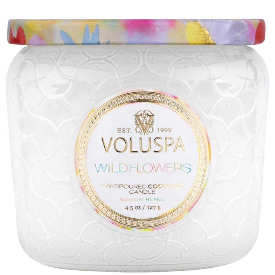 White glass jar with colorful metallic lid. Wildflowers Voluspa Candle.