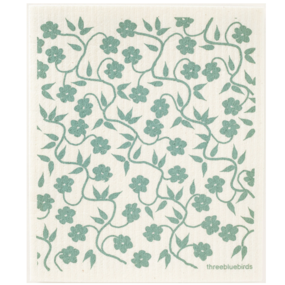 Square, off-white dish towel with green vine/ flower motifs all over photographed on white background.