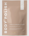 Rectangular, sealed, mauve package with white lettering that reads "BODY POLISH" on side and "VANILLA BROWN SUGAR MOISTURIZING EXFOLIANT" on bottom right. Photographed on grey background. 