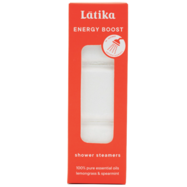A tall rectangular red box with clear window in center showing stack of white shower steamer cubes. White text on packing reads, "Latika Energy Boost Shower Steamers 100% Pure Essential Oils Lemongrass and Spearmint". Photographed on white background. 