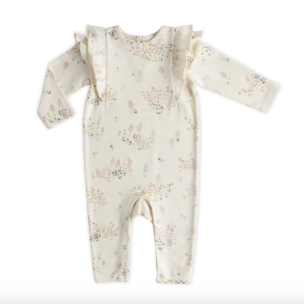 An ivory colored baby romper with mauve, orange, and pale blue flower print all over and small ruffles at shoulders. Photographed on white background. 