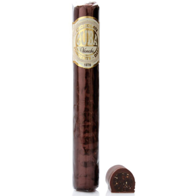 A cigar shaped chocolate wrapped in cellophane packaging and and cigar-like label that reads "Chocolate CUBA Venchi" next to a cut piece of chocolate cigar showing fondant and hazelnut filling dipped in dark chocolate. 