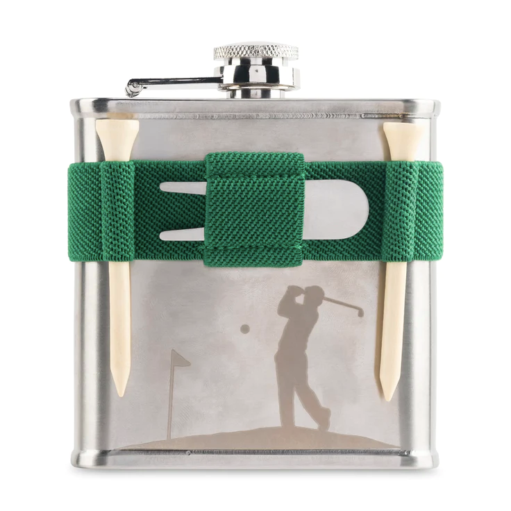 A stainless steel flask with golfing design on bottom with green band holding two golf tees and divot tool. Photographed on white background.
