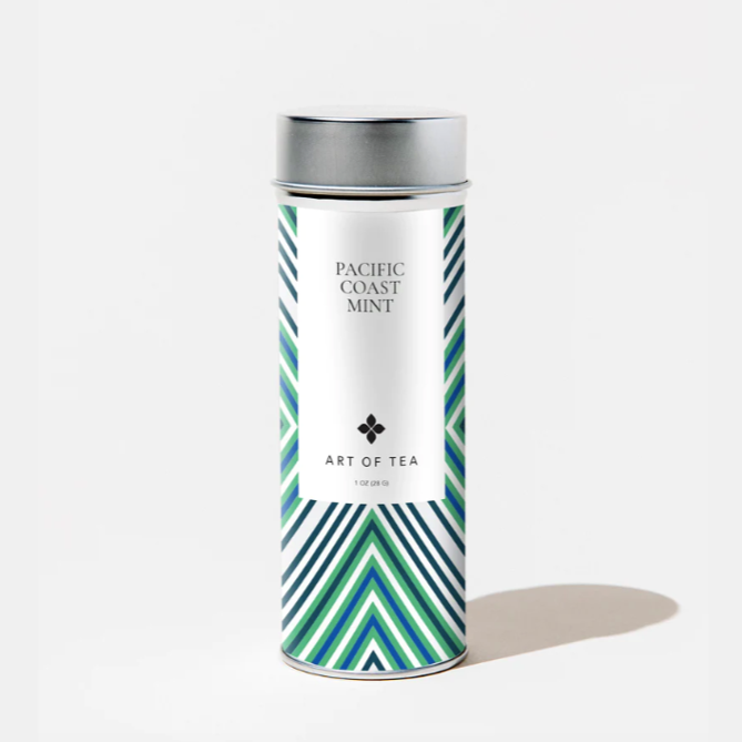 A cylindrical tea tin with silver metal cap and green, blue, and white chevron design all over. White label on tin has black text that reads, "Pacific Coast Mint Art of Tea". Photographed on white background