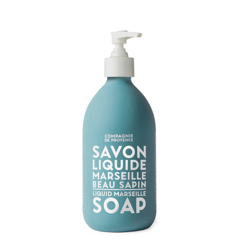 Light blue soap bottle with white pump to dispense hand soap. Soap bottle has white text printed on the front that reads "Savon LIquide Marseille Beau Sapin"