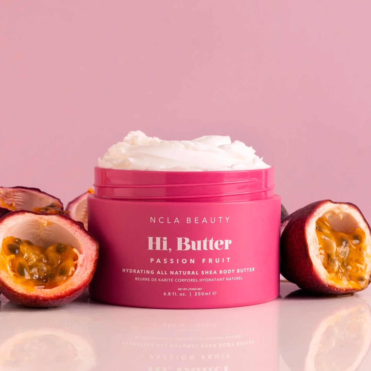 NCLA Hi, Butter pink container with passionfruits surrounding the container.