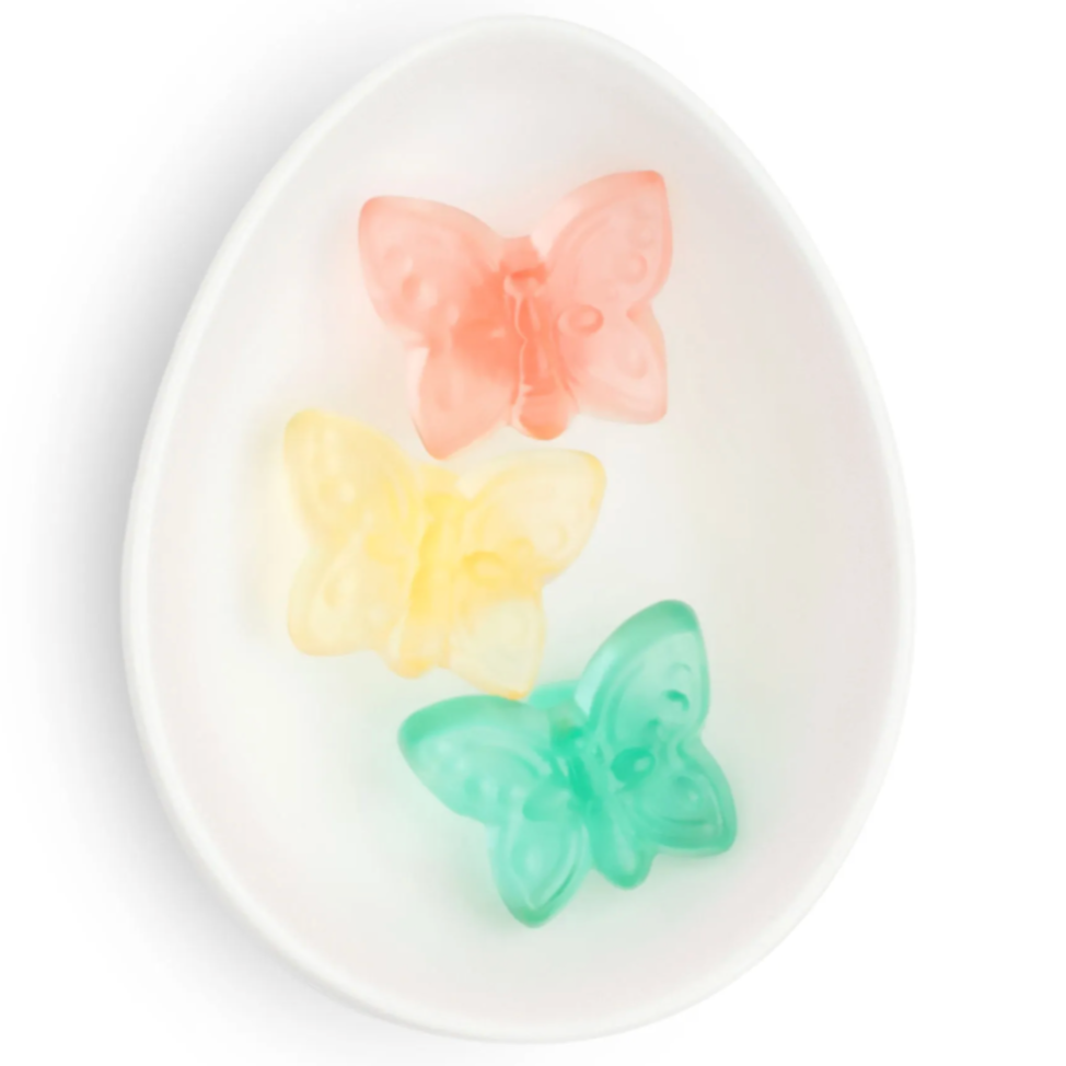 White ceramic dish with a pink, a yellow and a green baby butterfly each.