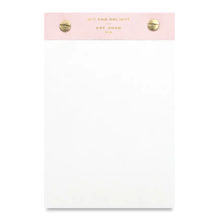 White notepad with pink top and gold detail.