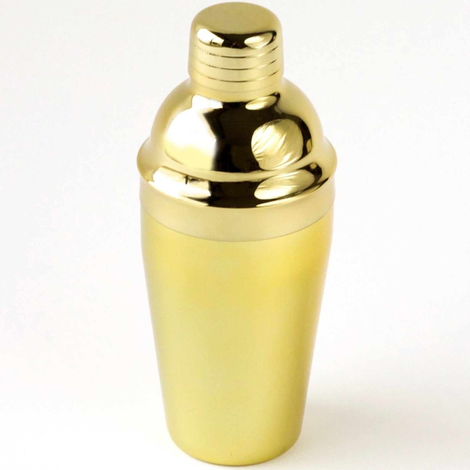 A gold cocktail shaker sitting on a white background.