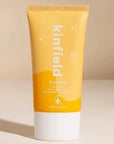 yellow and orange sunscreen bottle with white lid. has white text reading "Kinfield Sunglow Laminating Sunscreen" 