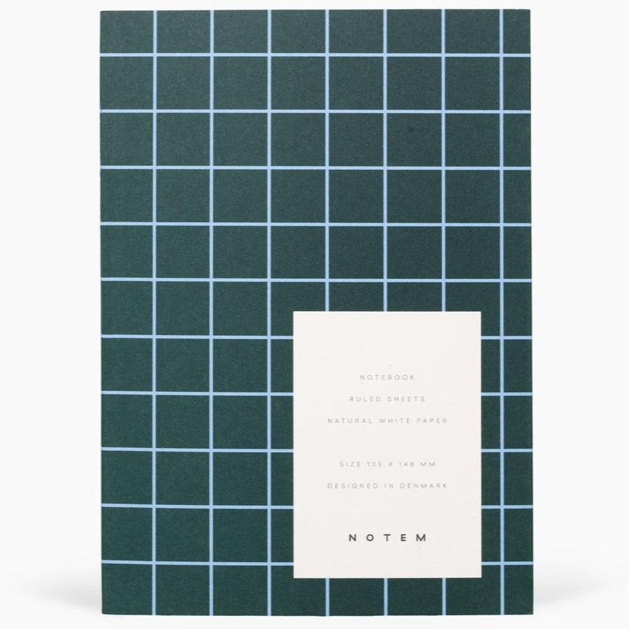 Dark green notebook with light blue grid lines.