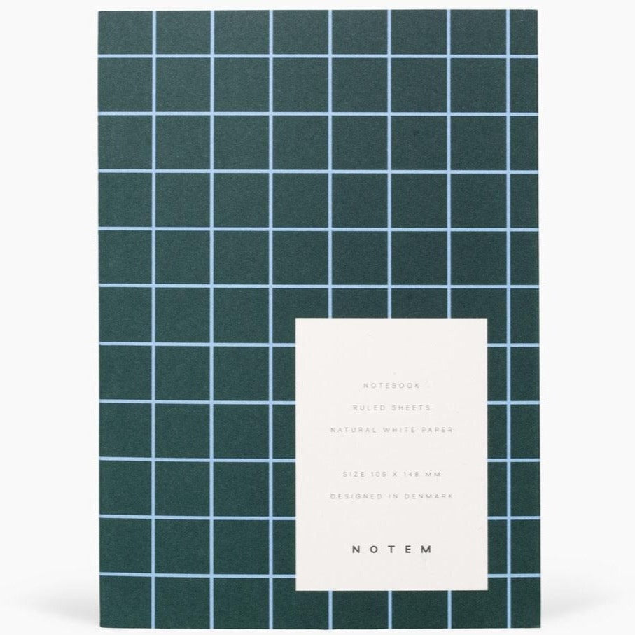 Dark green notebook with light blue grid lines.