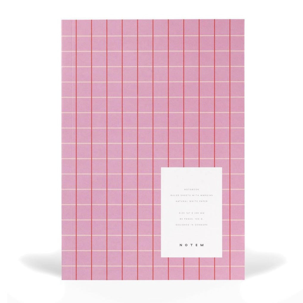 Pink notebook with red and cream colored gridded stripes.