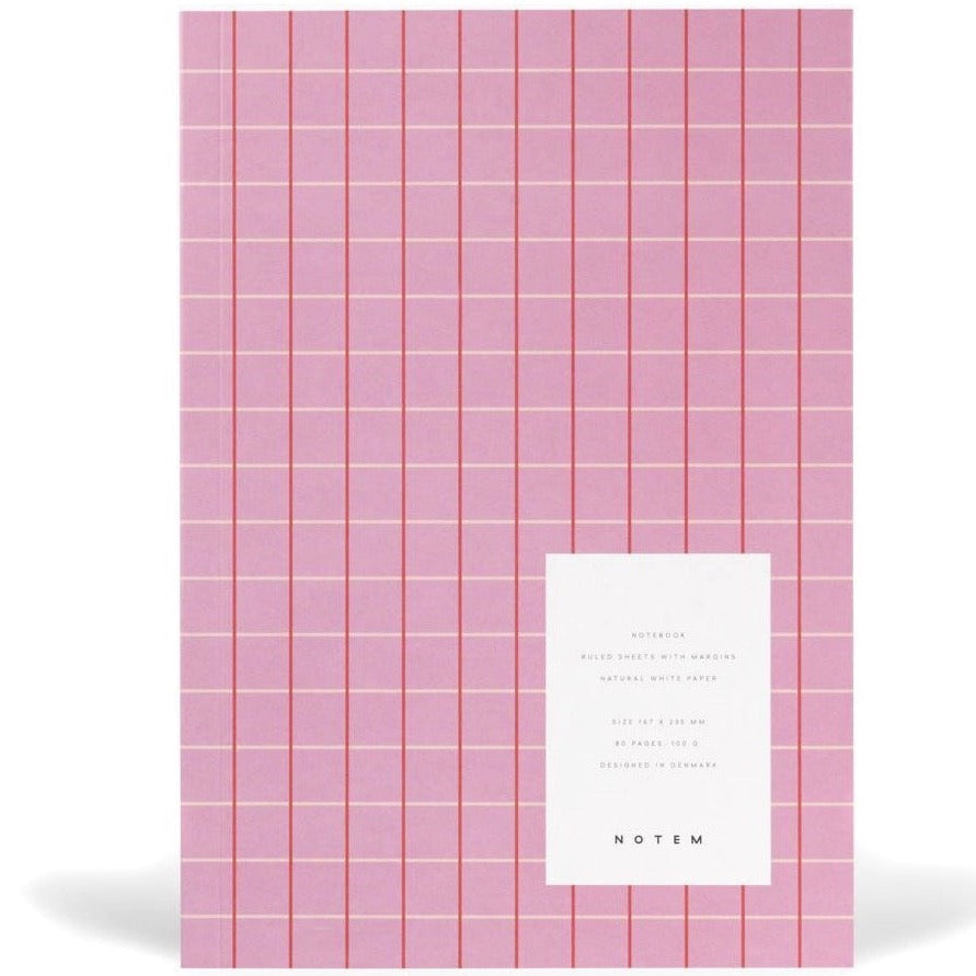 Pink notebook with red and cream colored gridded stripes.