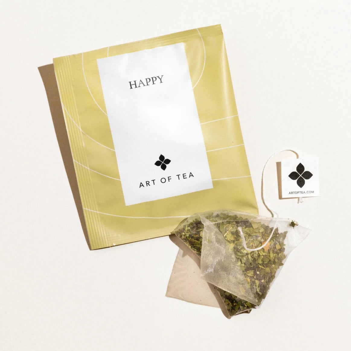 Yellow square packaging with tea sachet outside and to the side.