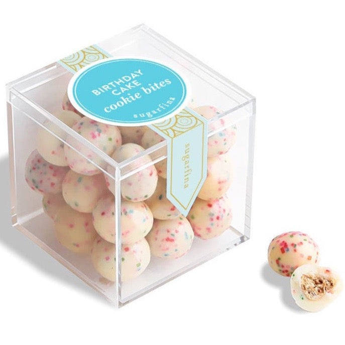 Clear plastic cube with pink and blue speckled birthday cake cookie bites inside