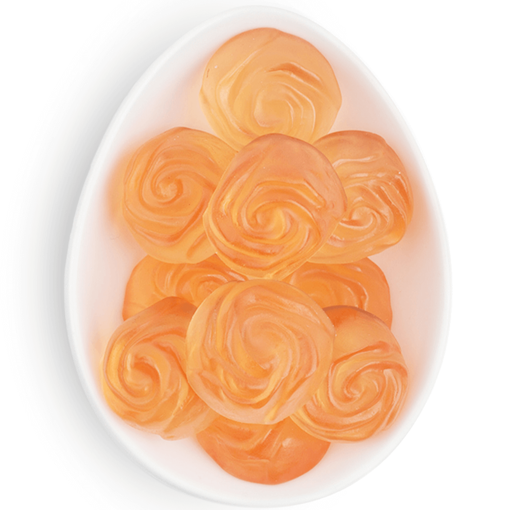 Small white ceramic dish holding rose-shaped pink gummy candies.