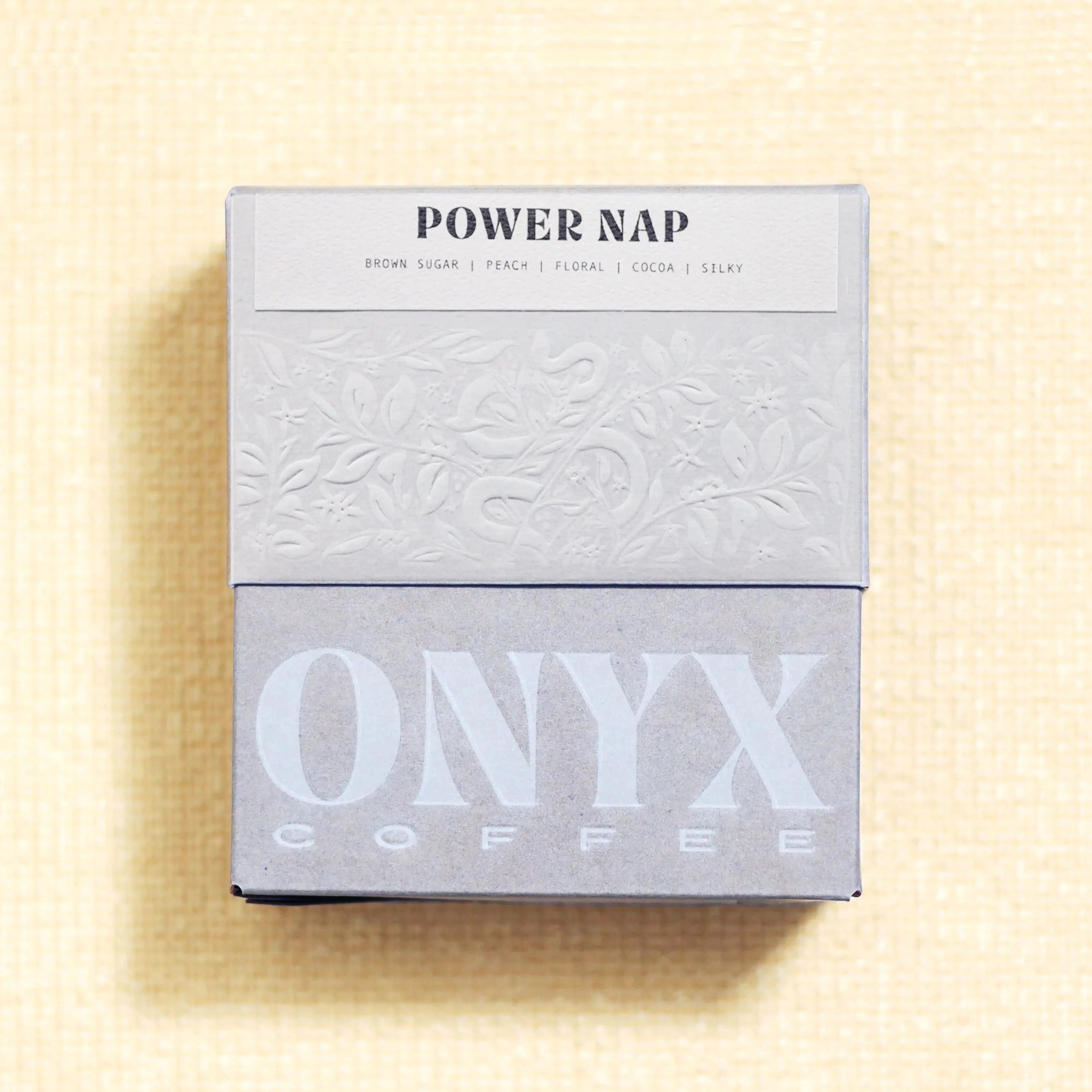 gray packaging for the onyx power nap coffee on a yellow background