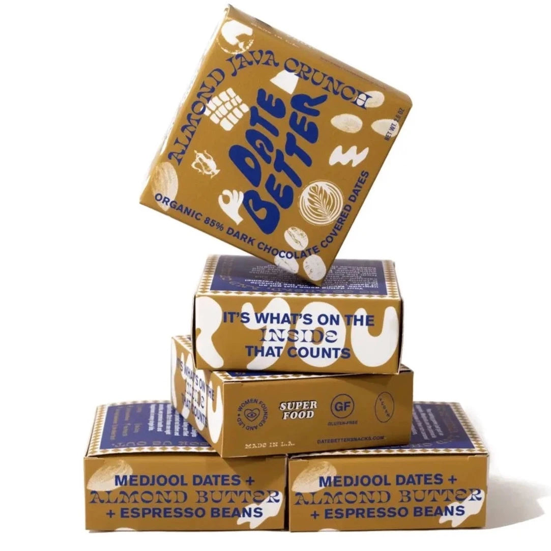 date better almond java crunch boxes stacked onto of each other. This shows the various prints on the other sides of the boxes. Text is either navy blue or white on a mustard color box.