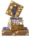 date better almond java crunch boxes stacked onto of each other. This shows the various prints on the other sides of the boxes. Text is either navy blue or white on a mustard color box.