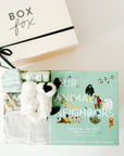 BOXFOX Original creme New Family Gift Box packed with PEHR cozy grey kimono onesie 3-6 months, Jellycat puppy lovey, Our Animal Neighbors book, Pipette baby oil, Alva sage green teether, and Alva sage green beanie.