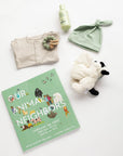 PEHR cozy grey kimono onesie 3-6 months, Jellycat puppy lovey, Our Animal Neighbors book, Pipette baby oil, Alva sage green teether, and Alva sage green beanie laid out on white background.